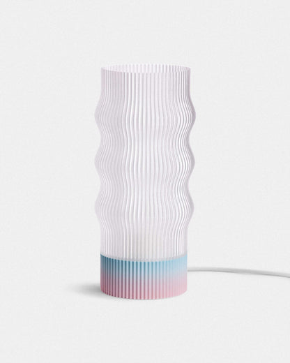 White textured lamp with a gradient blue base on a light gray background