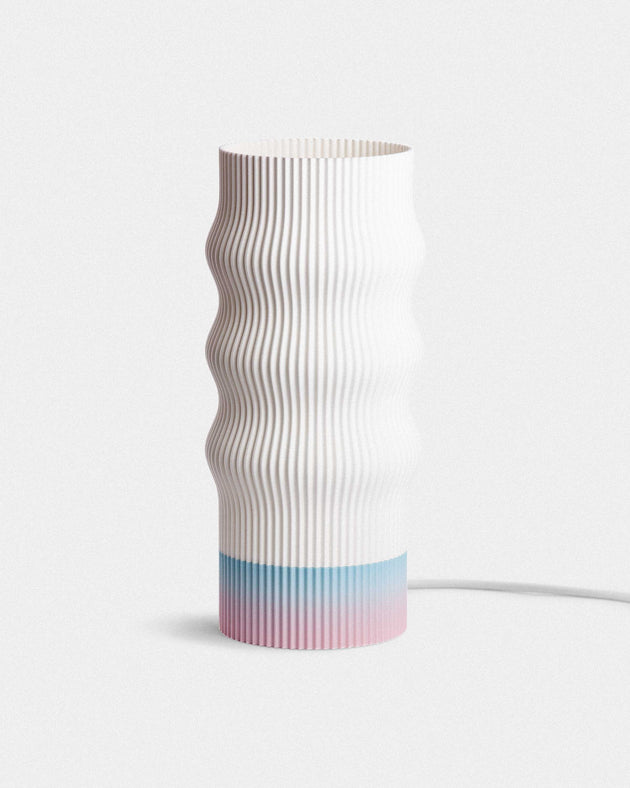 Table lamp with wavy design and gradient color on a white background