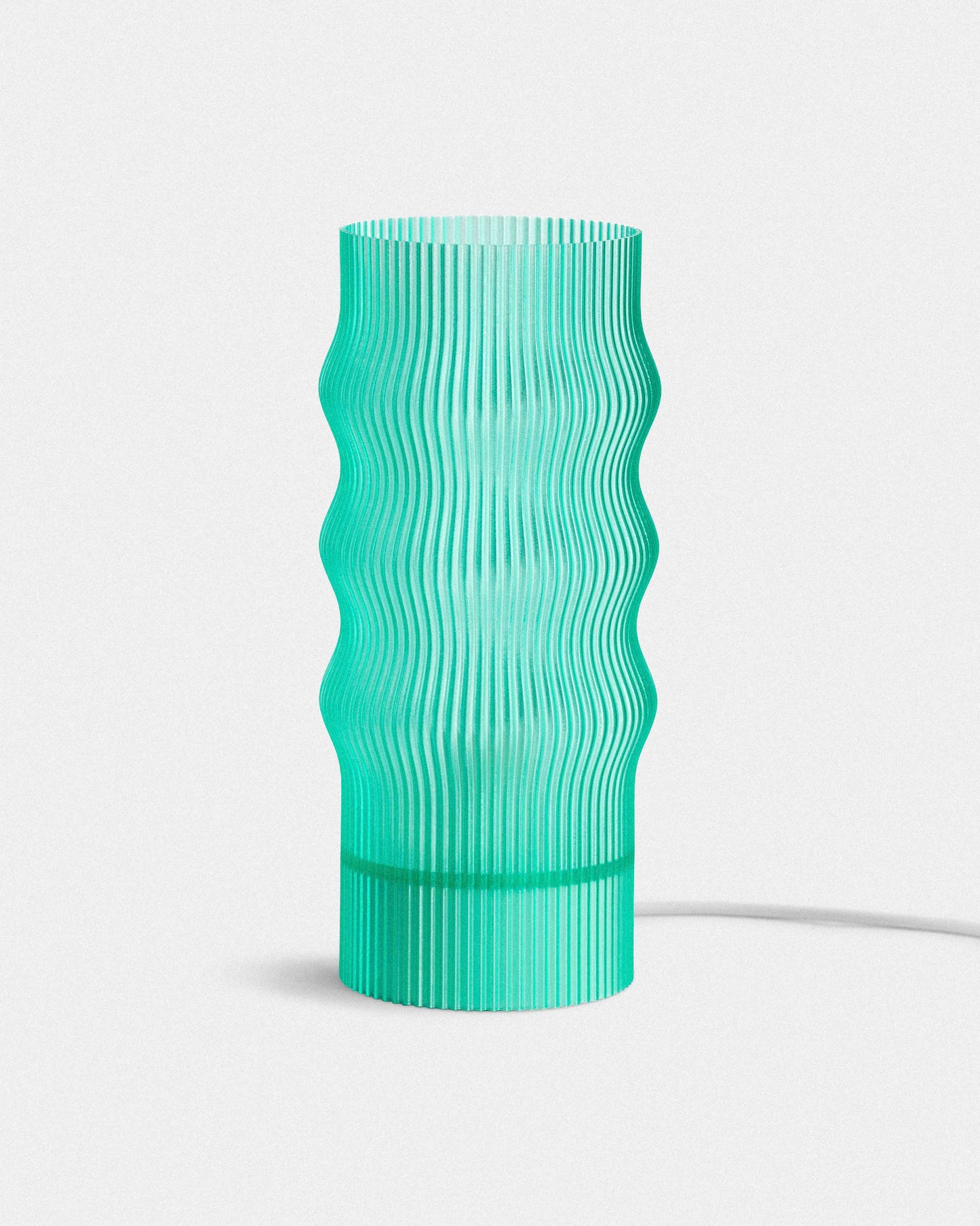 Green textured table lamp on a white background