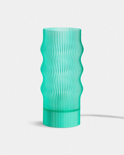 Green textured table lamp on a white background