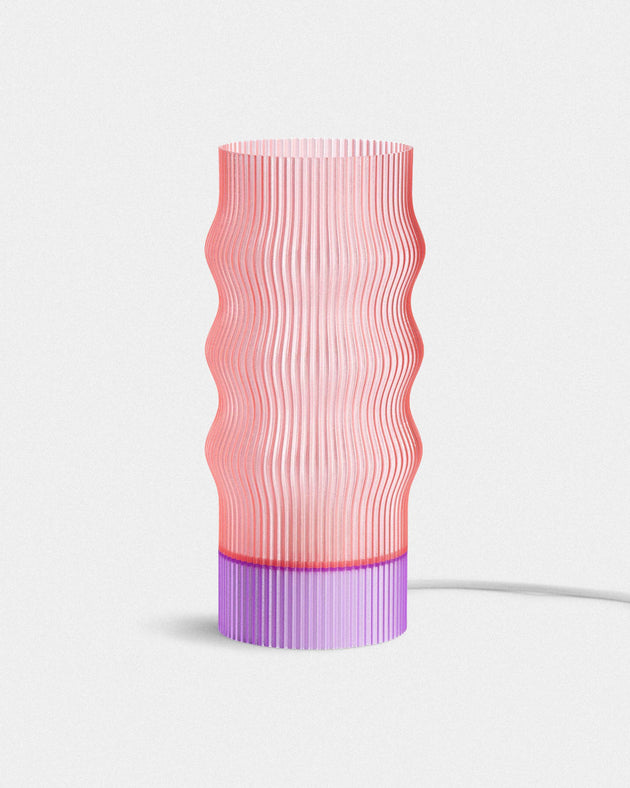 Pink and purple textured table lamp on a white background